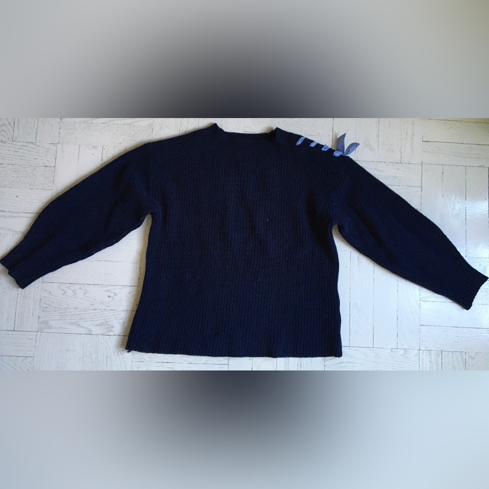 Navy cotton sweater with blue stripe bows on shoulders.